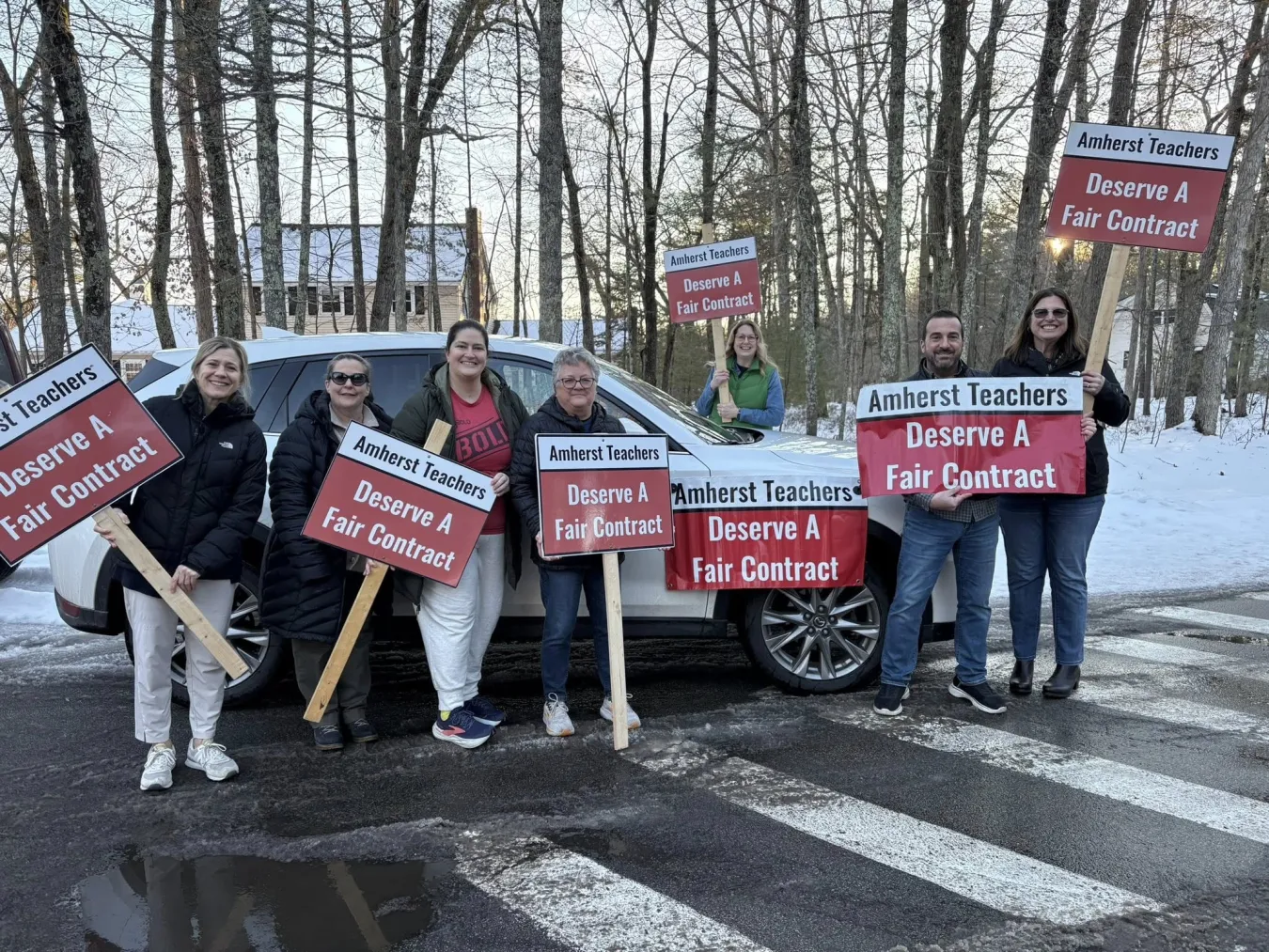 Amherst educators hold signs pushing for a fair contract