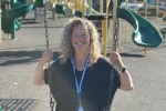 ESP Sue Eno sits on a swing at an Exeter playground