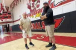 Claremont School District custodial and maintenance staff members Joe Szelangowski and Trevor Rouleau stand in the Stevens High School gymnasium.