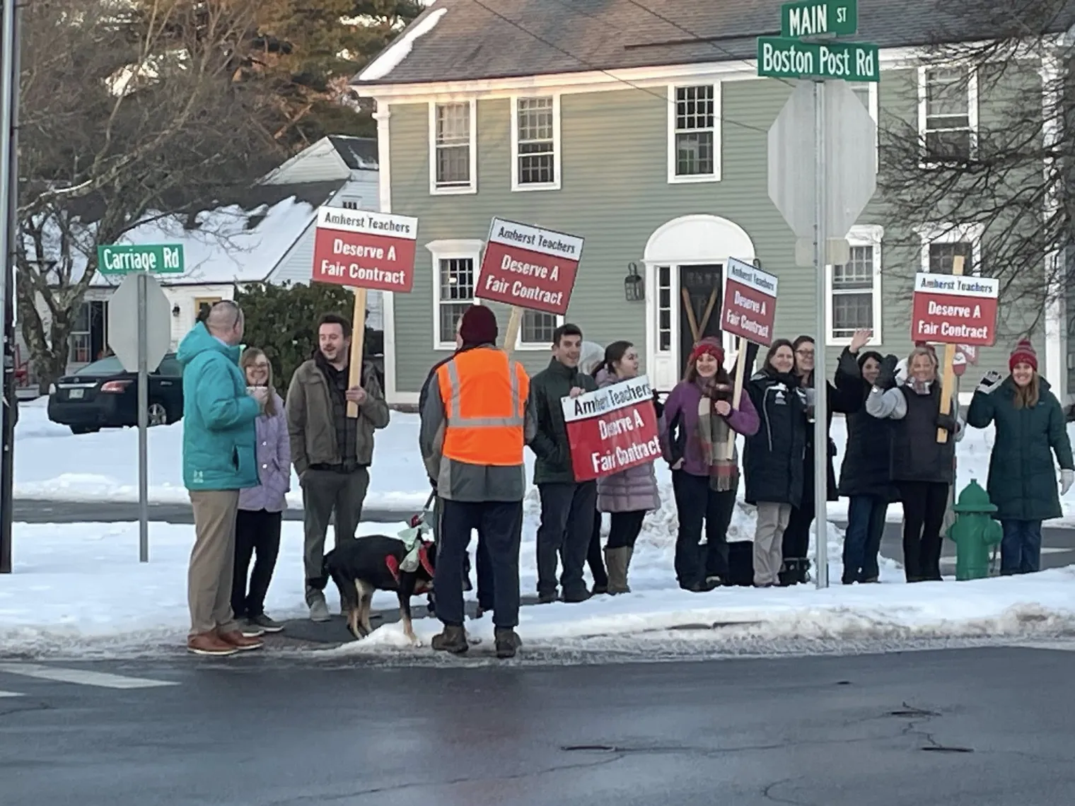 Amherst educators hold signs advocating for a fair contract