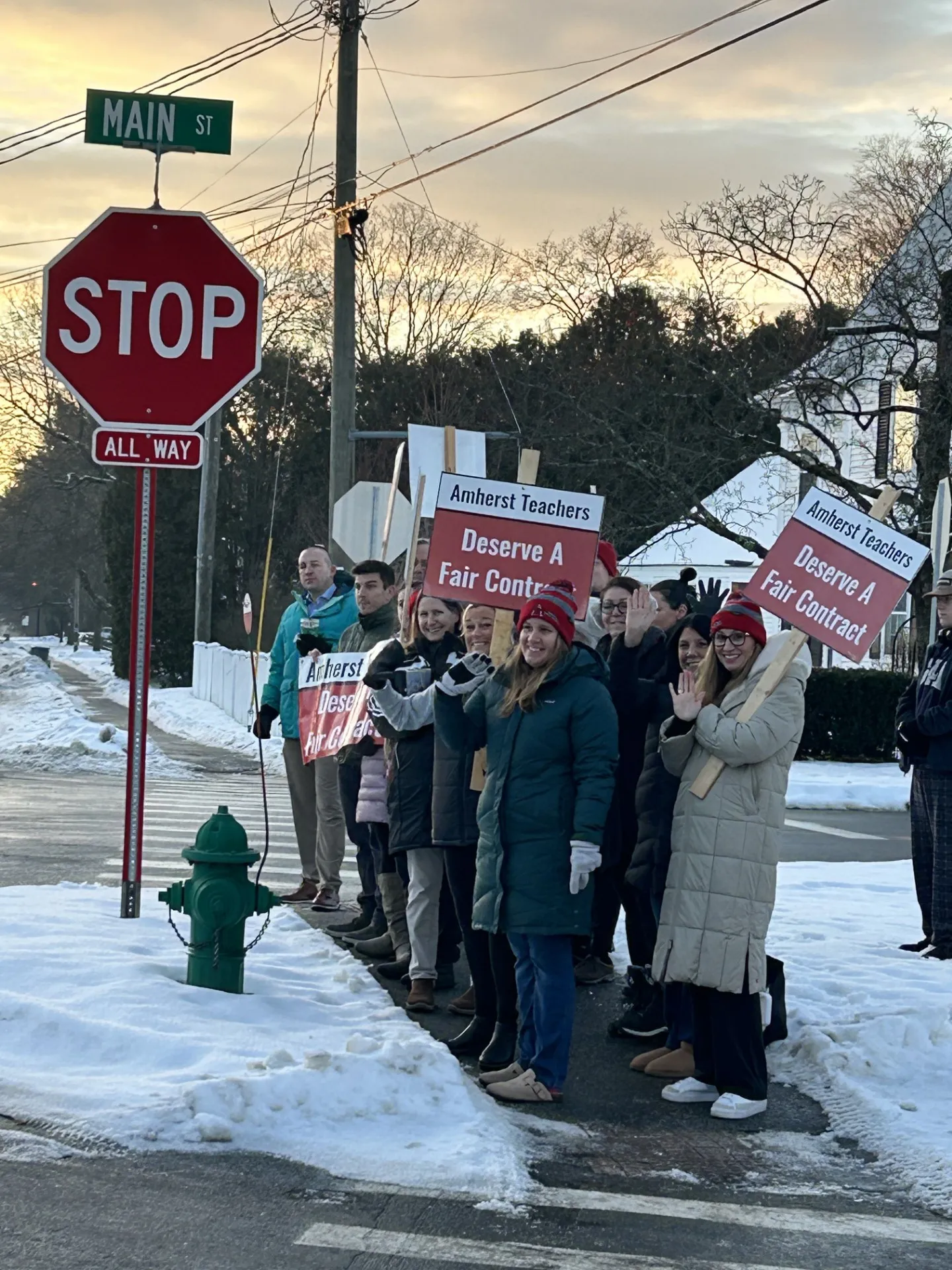 Amherst educators hold signs advocating for a fair contract