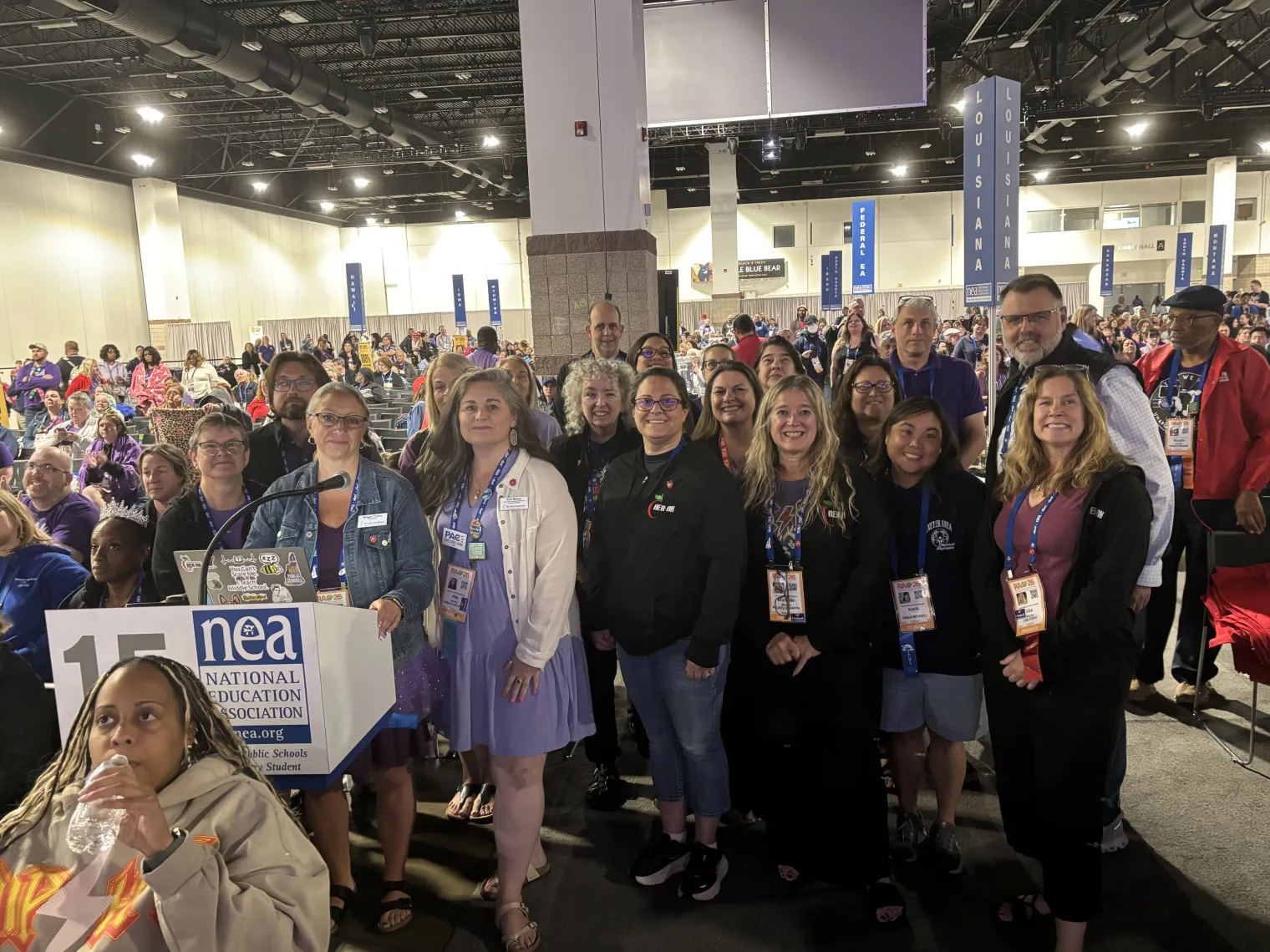 NEA-NH delegates to the 2026 NEA RA stand on the floor to honor member Christa McAuliffe