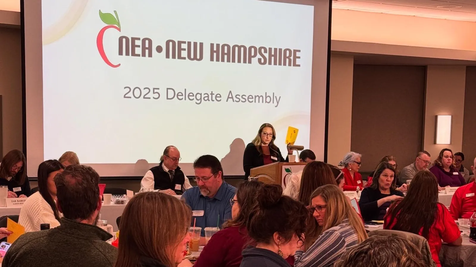 An image of NEA-NH President Megan Tuttle leading the 2025 Delegate Assembly. 