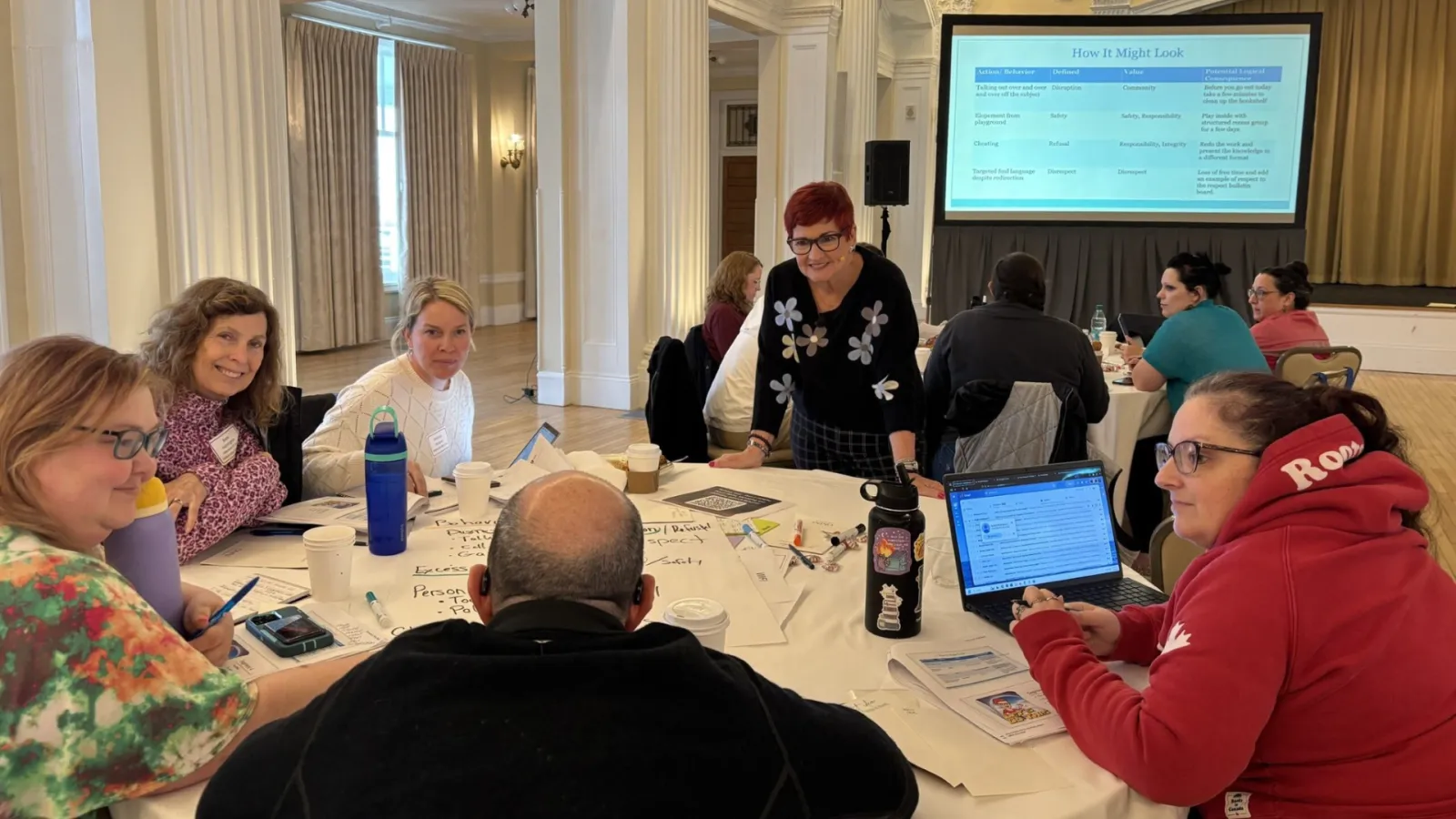 NEA-NH members smile as they talk and learn together at a professional development session.