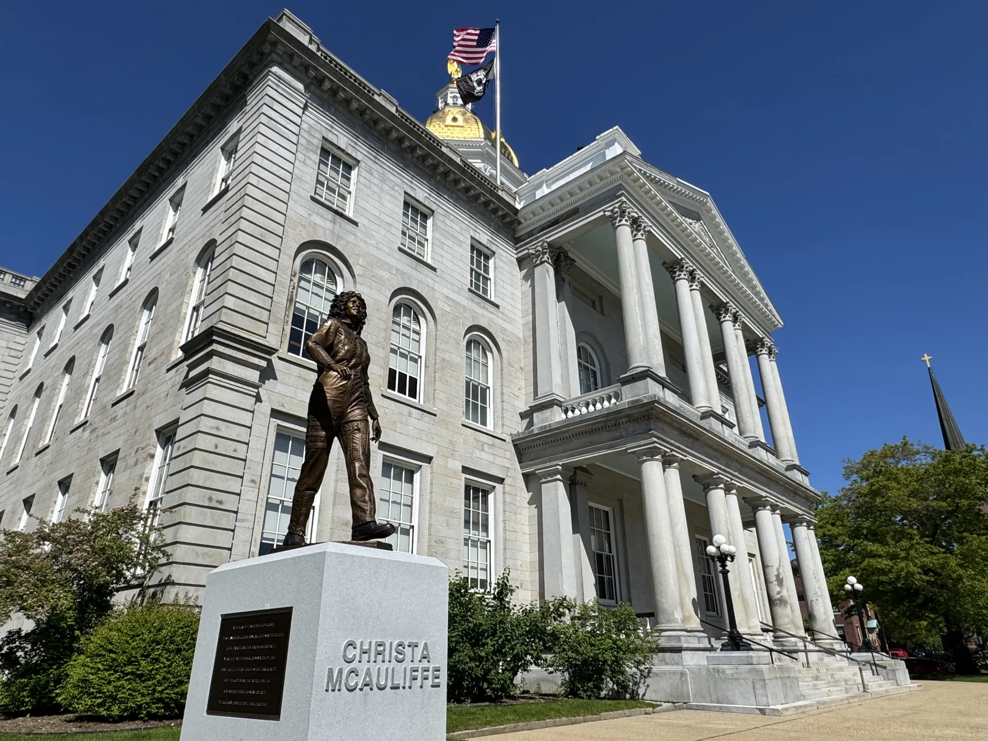 An image of the Christa McAuliffe statue at the New Hampshire State House in spring.