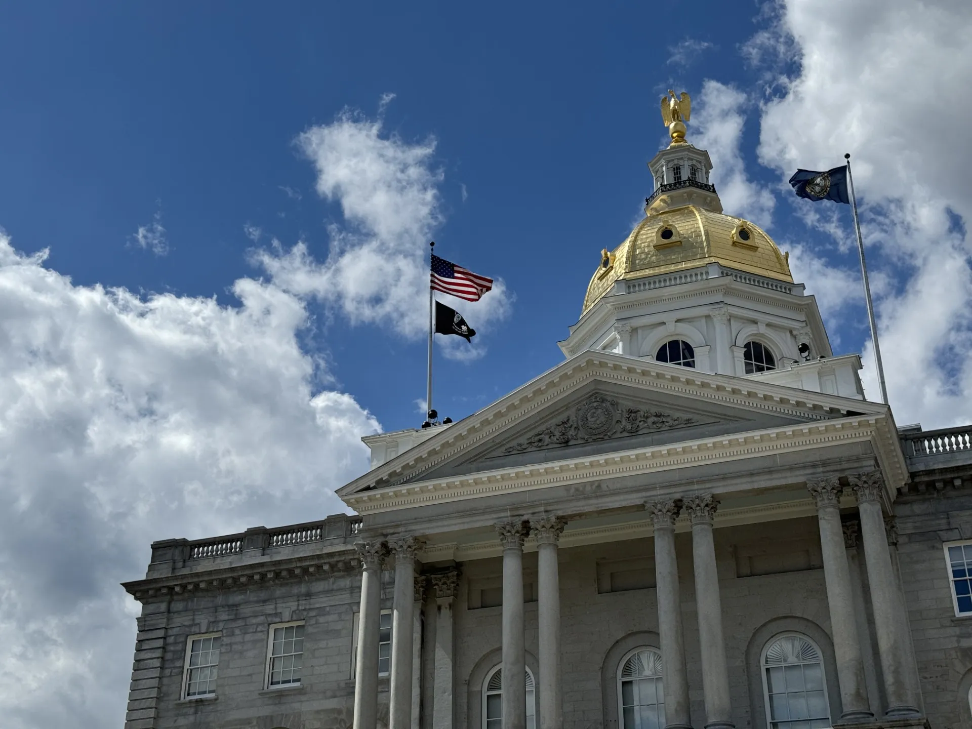 An image of the New Hampshire State House in summer.