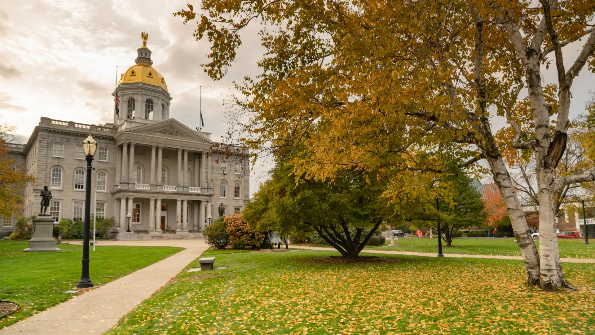 A picture of the NH Statehouse in the fall.