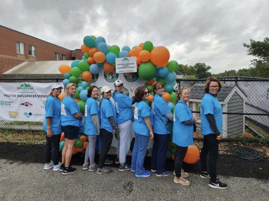 Exeter paraprofessionals pose together at a fundraiser.