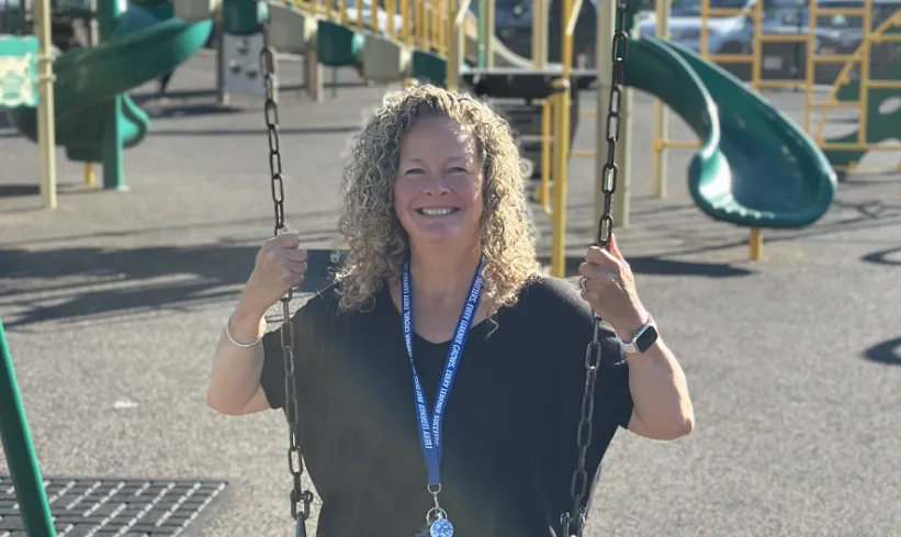 ESP Sue Eno sits on a swing at an Exeter playground