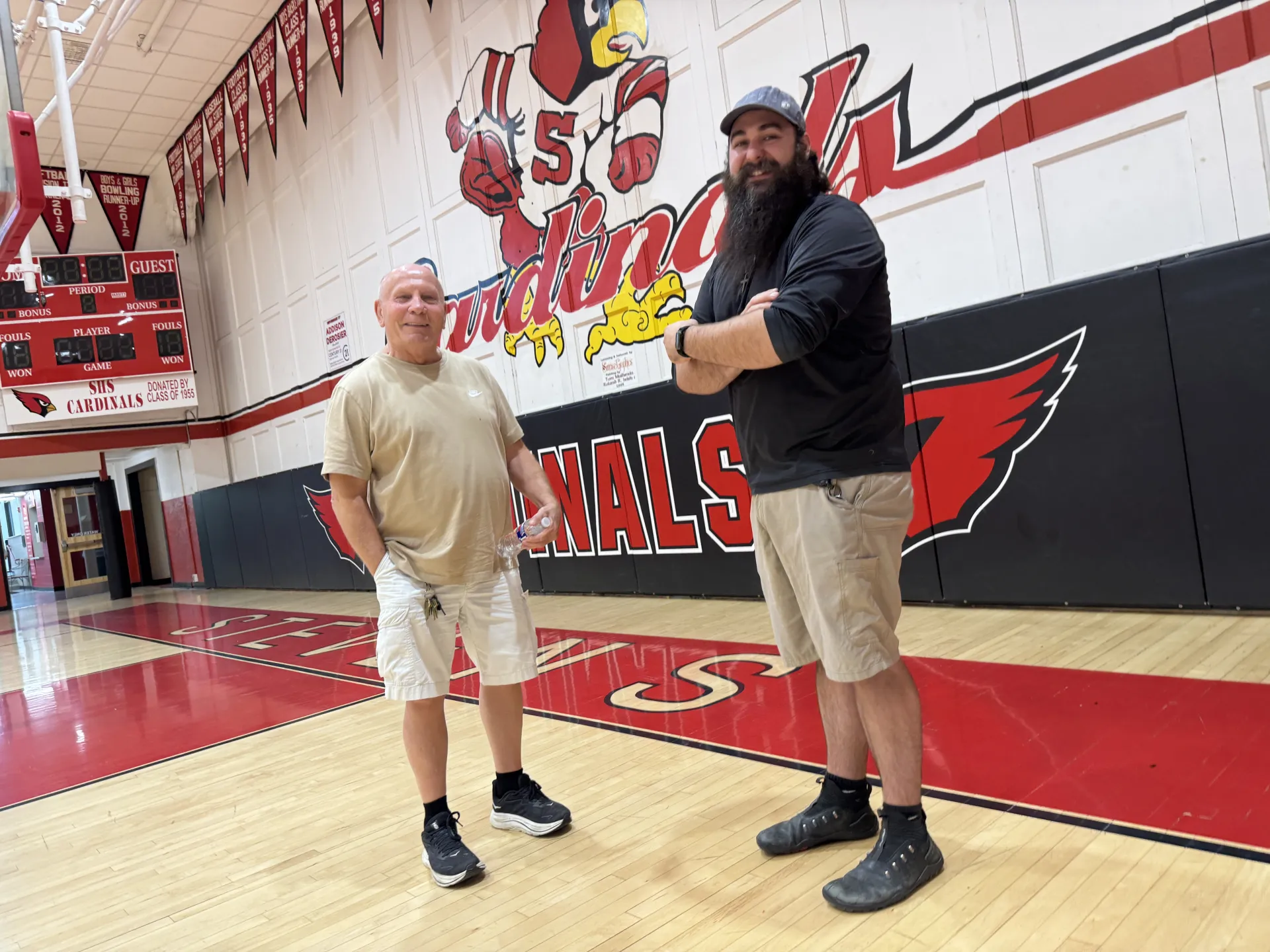 Claremont School District custodial and maintenance staff members Joe Szelangowski and Trevor Rouleau stand in the Stevens High School gymnasium.