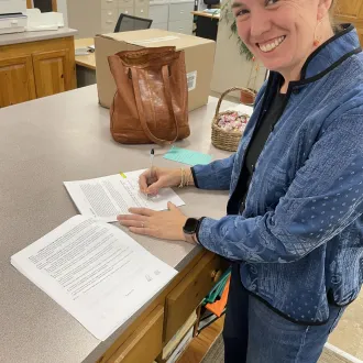 Middleton EA Co-President Alison Hayford signs the union's first contract.