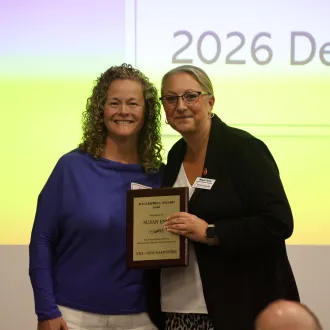 NEA-NH President Megan Tuttle presents Sue Eno with the 2026 Jo Campbell Award at the NEA-NH Delegate Assembly