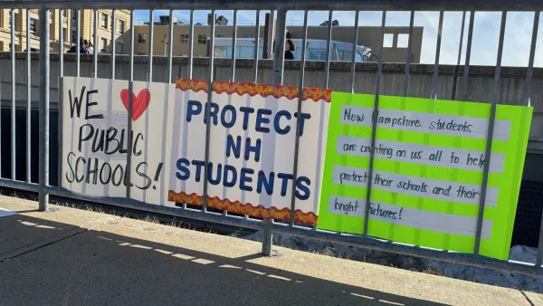 A sign reads "Protect NH Students"