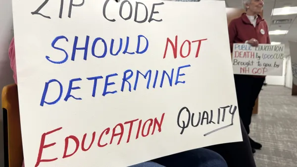 A sign reads: Zip code should not determine education quality. 